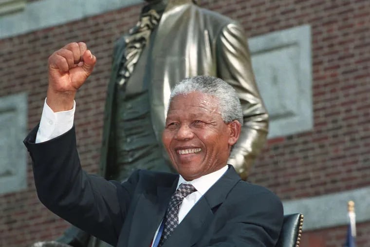 Nelson Mandela raising his fist in Philadelphia in 1993, when he shared the Liberty Medal with F. W. de Klerk, South Africa's last white president. They also won a Nobel Peace Prize. J. SCOTT APPLEWHITE / AP