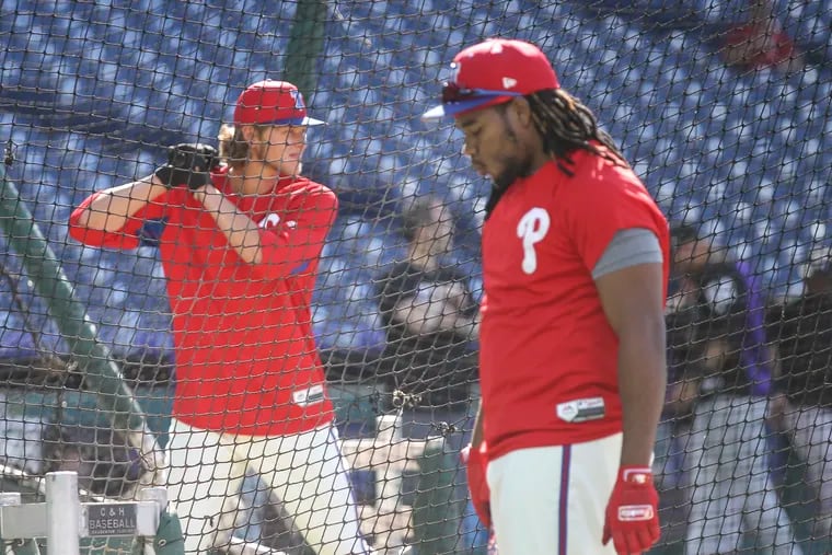 Phillies Maikel Franco waits while 2018 first-round pick Alec Bohm takes batting practice.