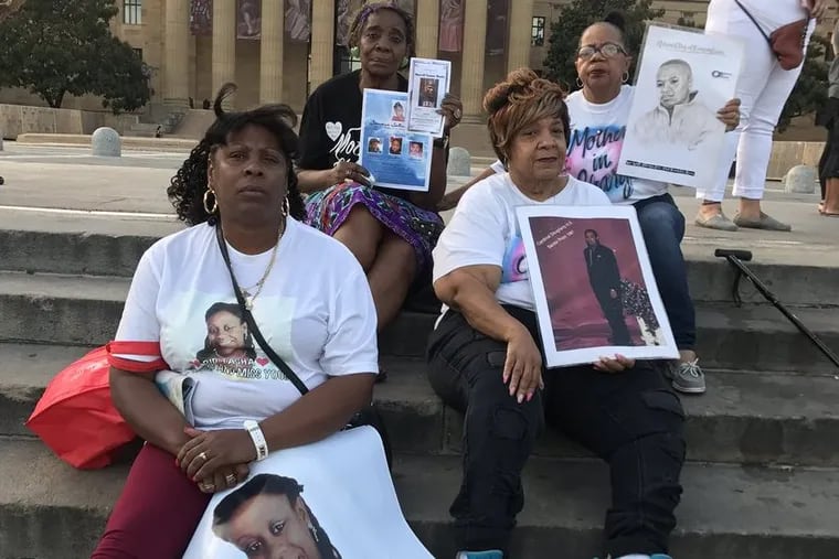 People gather at the Philadelphia Museum of Art for an event honoring murder victims in Philadelphia.