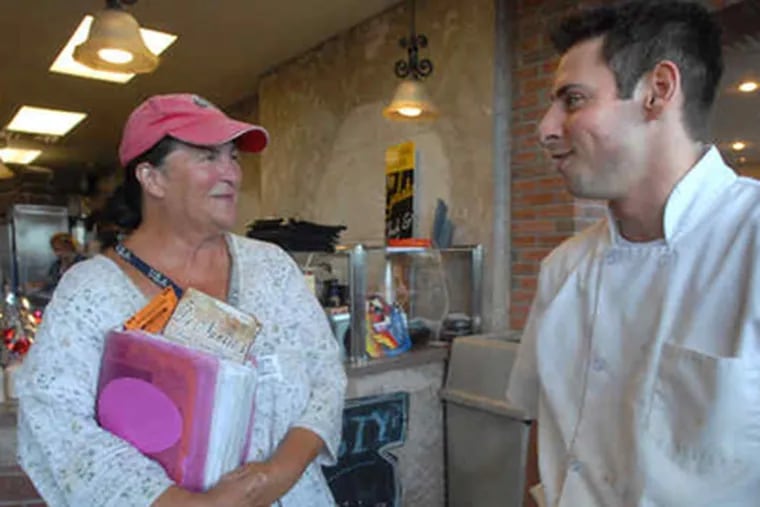 At DeNunzio's Brick Oven Pizza in Sea Isle City, Lana Samuels solicits a donation from manager Mike DeNunzio. (April Saul / Staff Photographer)