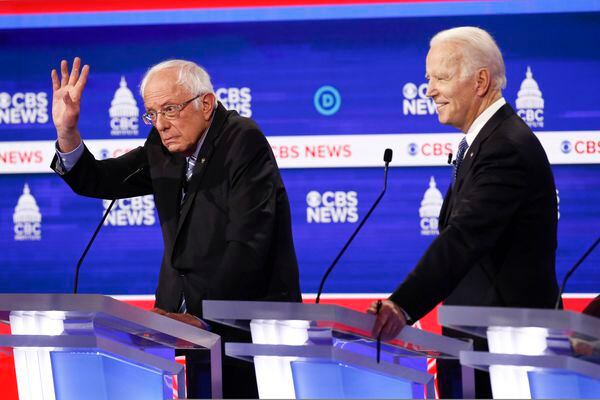 Bernie Sanders takes hits at Democratic debate while gaining spotlight as front-runner