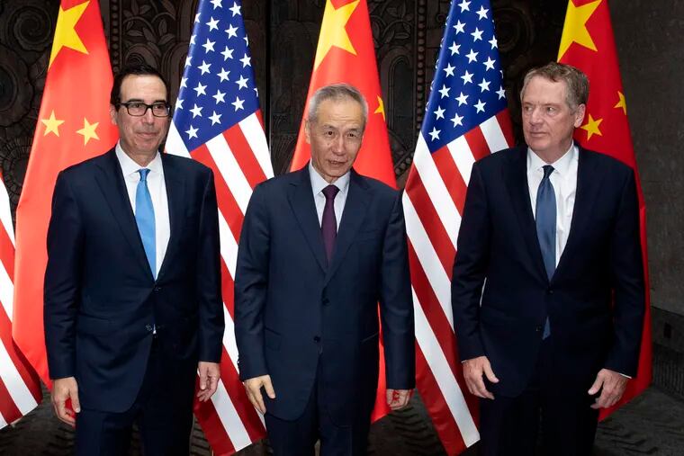 Chinese Vice Premier Liu He, center, poses with U.S. Trade Representative Robert Lighthizer, right, and Treasury Secretary Steven Mnuchin, for photos before holding talks at the Xijiao Conference Center in Shanghai Wednesday, July 31, 2019. (AP Photo/Ng Han Guan, Pool)