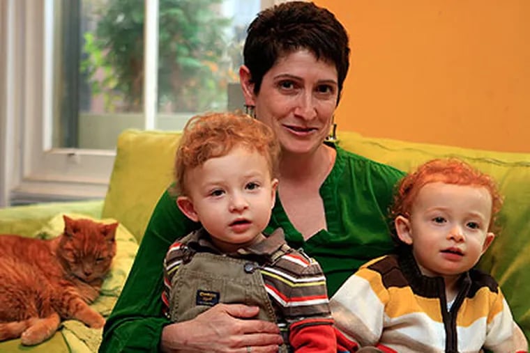 Karen Misher, the mother of two-year-old twins Nathaniel (left) and Alexander, in their home in Philadelphia's Fairmount section. (Akira Suwa / Staff Photographer)