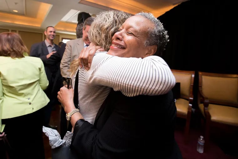 Adina T. Laver, CEO of Courage to Be Curious L.L.C., gets a hug from Donna Allie (right), of Team Clean Inc., after a discussion at the Radnor Country Club on companies and the obstacles they face.