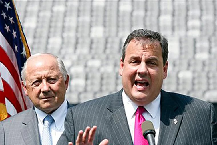 Gov. Christie with Jon F. Hanson, whose panel reviewed the state's gambling, entertainment, and sports industries. (Mel Evans / Staff)