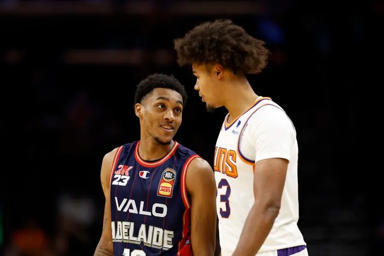 ACTION NETWORK USE ONLY - Craig Randall II #12 of the Adelaide 36ers talks to Cameron Johnson #23 of the Phoenix Suns during the second half at Footprint Center on October 02, 2022 in Phoenix, Arizona. The 36ers beat the Suns 134-124. NOTE TO USER: User expressly acknowledges and agrees that, by downloading and or using this photograph, User is consenting to the terms and conditions of the Getty Images License Agreement. (Photo by Chris Coduto/Getty Images)