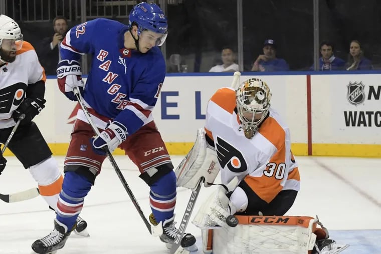 Flyers goalie Michal Neuvirth deflects a shot by Rangers left winger Matt Puempel during the second period.