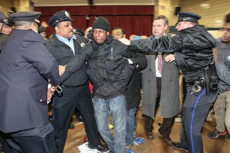 When the Lawncrest town hall meeting started protesters moved in on the panel, with the Police Commissioner and the DA, a melee ensued resulting in about a dozen arrests on Mar. 20, 2015. (STEVEN M. FALK / Staff Photographer)