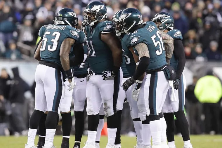The Eagles defense huddle against the Atlanta Falcons in a NFC Divisional Playoff game on Saturday, January 13, 2018 in Philadelphia. YONG KIM / Staff Photographer