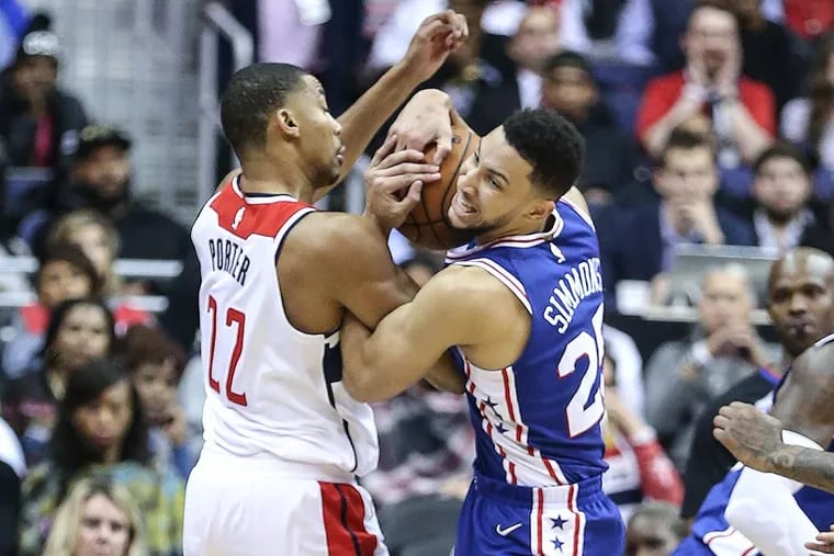The Philadelphia Ben Simmons, right, and the Washington Wizards’ Otto Porter Jr. wrestle for the ball during the third quarter at the Capital One Arena in Washington, D.C., on Wednesday, Oct. 18, 2017. The Wizards won, 120-115.