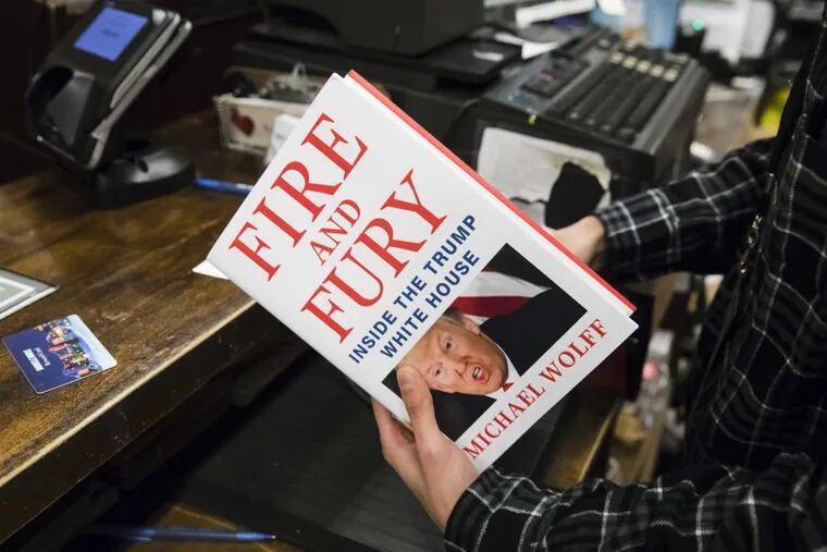 A salesperson rings up a copy of the book &quot;Fire and Fury: Inside the Trump White House&quot; by Michael Wolff at a Barnes &amp; Noble store in Philadelphia, Friday, Jan. 5, 2018.