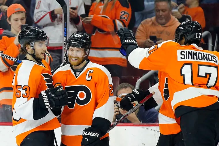 Flyers' Claude Giroux celebrates his first-period goal with teammates Shayne Gostisbehere and Wayne Simmonds against the Arizona Coyotes on Saturday, February 27, 2016 in Philadelphia.  YONG KIM / Staff Photographer