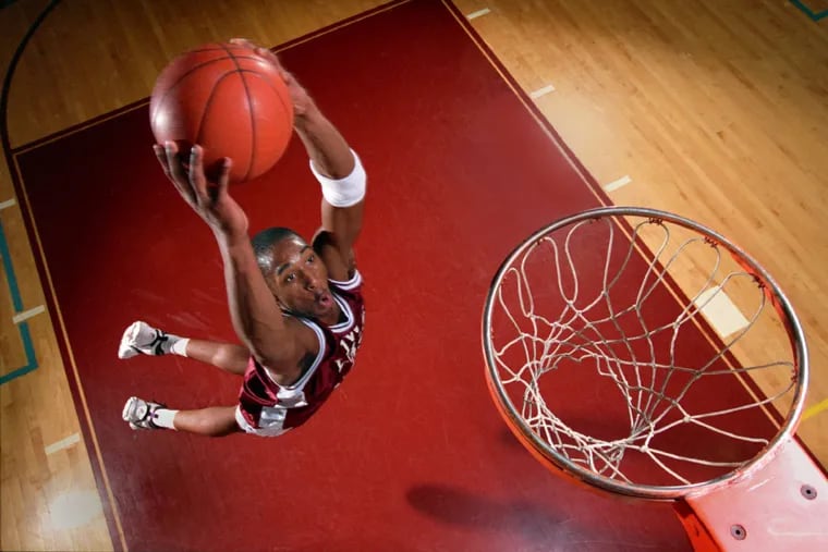 Kobe Bryant flying through the air for a dunk during an Inquirer photo shoot while he was at Lower Merion High School in 1995.