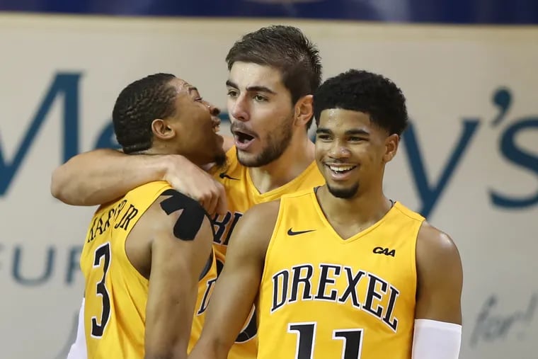 L-R: Troy Harper, Alihan Demir, and Camren Wynter of Drexel after Demir made a basket and got fouled late in the game at Tom Gola Arena on Nov. 17, 2018.    CHARLES FOX / Staff Photographer