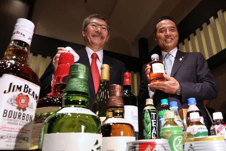 Suntory Holdings, the Japanese company that in January announced a $16 billion deal to buy the U.S. whiskey-maker Beam Inc., for the first time will have someone outside the founding family as president. At a Tokyo news conference Tuesday, Nobutada Saji (left), Suntory chairman and CEO, posed with incoming president Takeshi Niinami, 55, who previously was chairman of the convenience-store operator Lawson Inc. and who takes his post Oct. 1.