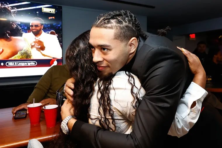 Paulsboro native Seth Lundy receives a hug at the Empire Sports Bar in Brooklawn, New Jersey during a NBA Draft party. The Roman Catholic graduate finished his playing career at Penn State this year.