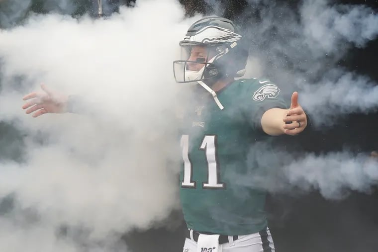 Eagles quarterback Carson Wentz walking into smoke during player introductions before the Eagles played the Jets on Sunday.