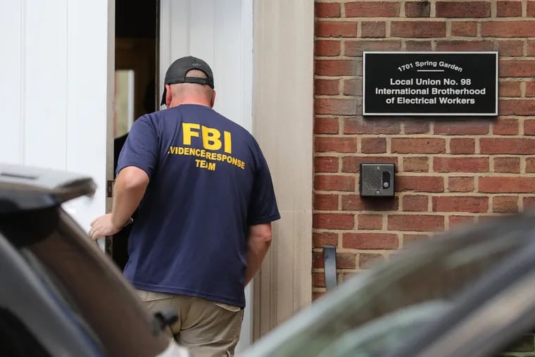 An FBI agent enters the offices of Local 98 of the International Brotherhood of Electrical Workers during a series of simultaneous raids on union offices, labor leader John Dougherty's home and those of several of his family members and allies.