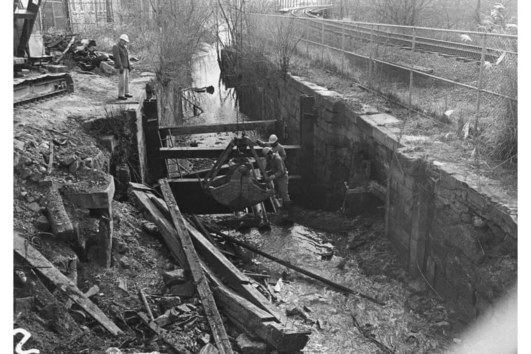 Men working on Lock 69 during a 1978-79 project to restore the canal, stabilize the lock and build a new towpath along Manayunk Canal.