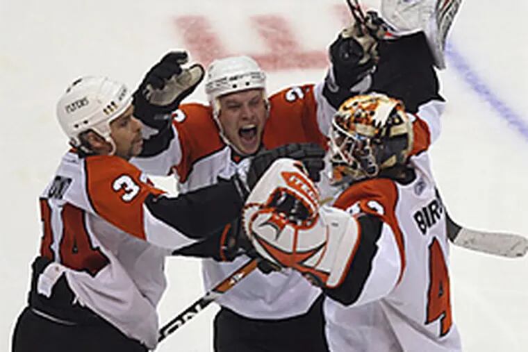 Jim Dowd, Patrick Thoresen and Martin Biron came together to celebrate the Flyers' overtime win in Game 7 against the Capitals. (Yong Kim/Daily News).