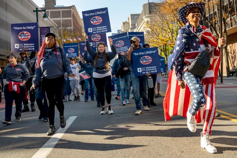 Tangela Logan (right), the “mascot” of the Veterans Multi Service Center marches with the group which serves over 6000 veterans and families annually throughout the tri-state area.
