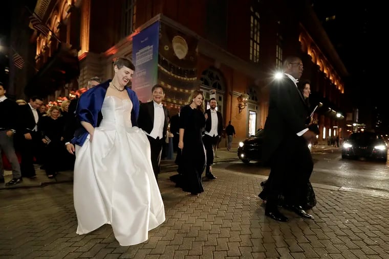 Guests leave the Academy of Music to walk up Broad Street to festivities at the Bellevue Hotel after the concert part of the Academy of Music 163rd Anniversary Concert and Ball ended on Jan. 25.