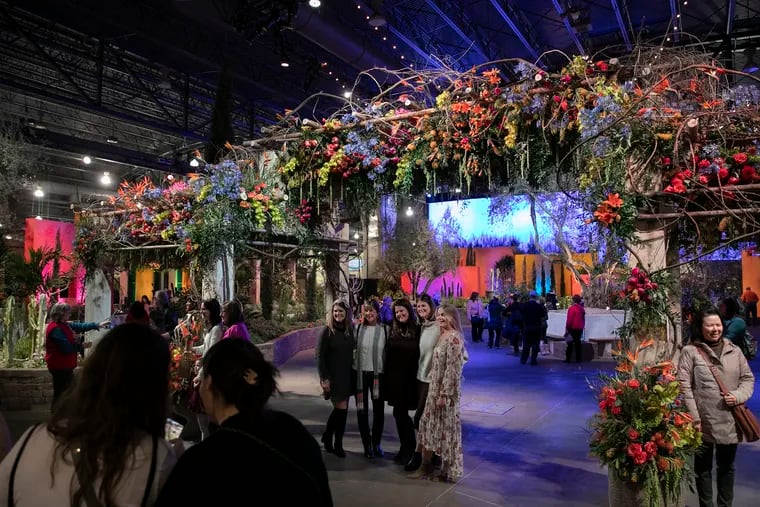 Guests take photos in the main entranceway of the 2020 Philadelphia Flower Show at the Pennsylvania Convention Center on its opening day, Saturday, Feb. 29, 2020. The show will be open until next Sunday, March 8, 2020.