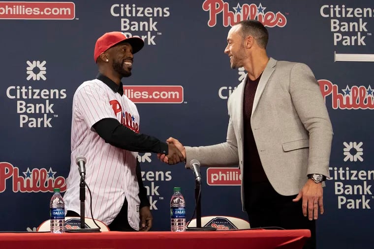 Phillies manager Gabe Kapler (right) shaking hands with new acquisition Andrew McCutchen during a December press conference.