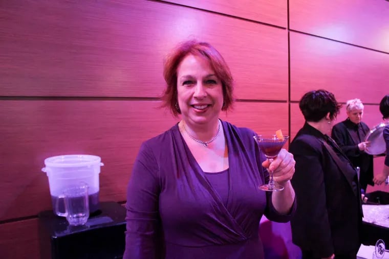 Katie Loeb at 2014's Dish It Up, a fund-raiser for Women Against Abuse, with a purple cocktail she created.