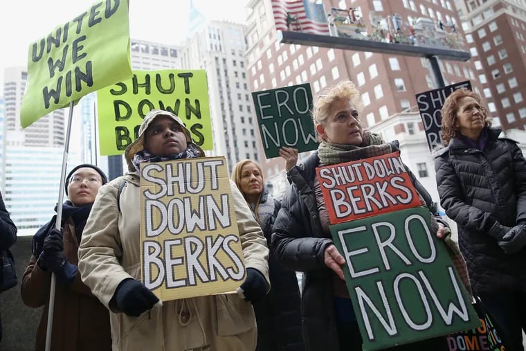 Winnifer Hernandez, center left, and Maria Del Carmen, center right, hold signs calling for the closure of the Berks County migrant detention center during a rally in front of the One Parkway Building in Center City Philadelphia in February 2020. Berks has long been the target of protests and lawsuits to try to force it to close.