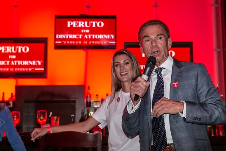 Chuck Peruto with his wife, Lindsey, addresses supporters at Chickie's & Pete's in South Philadelphia last week.