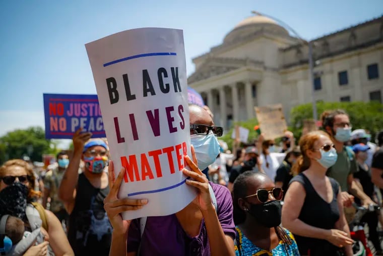 Protesters wear protective masks as they march after a Juneteenth rally outside the Brooklyn Museum, in New York. A loose network of Facebook groups that took root across the country in April to organize protests over coronavirus stay-at-home orders has become a hub of misinformation and conspiracies theories that have pivoted to a variety of new targets. Their latest: Black Lives Matter and the nationwide protests against racial injustice.