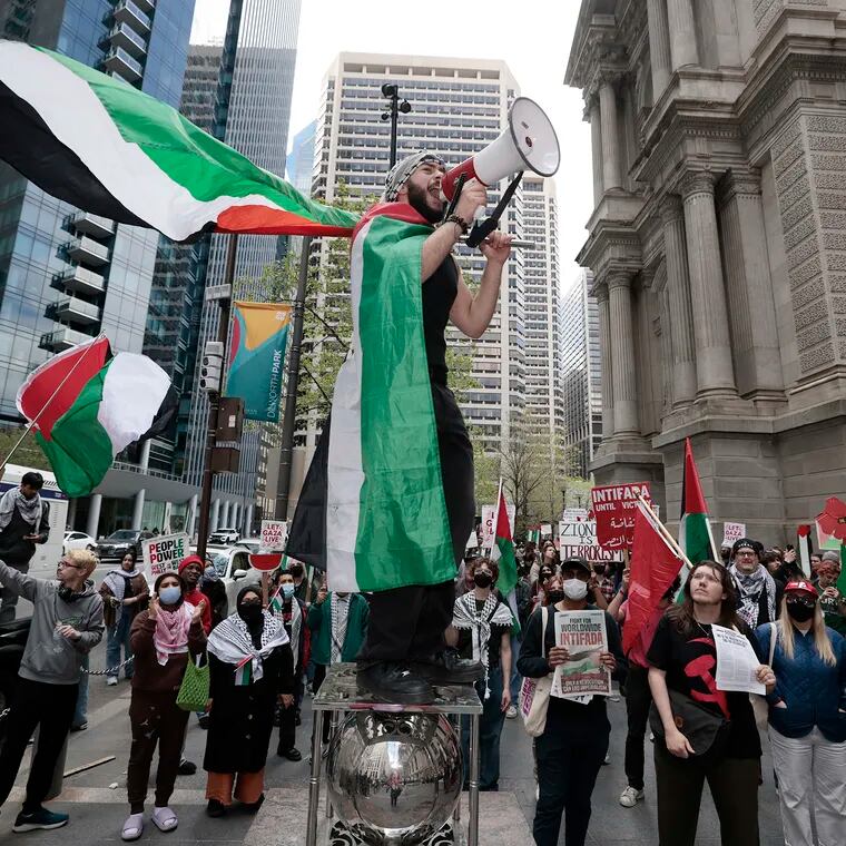 Qais Dana of Philadelphia gets people chanting “Palestine will be free” before the free Palestine march begins from City Hall in Philadelphia on Thursday.