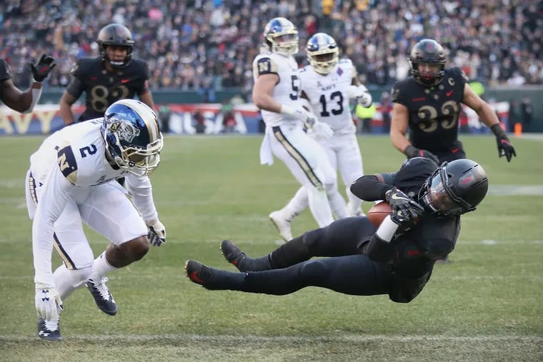 Army quarterback Kelvin Hopkins Jr. (8) tumbles into the end zone for a touchdown past Navy cornerback Jarid Ryan (2) in the first quarter.