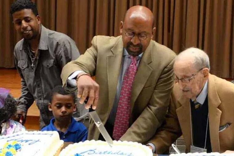 Daniel M. Rendine watches as Mayor Nutter cuts a centenarian cake at a June celebration of seniors in South Philadelphia.