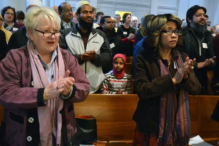 The multi-faith congregation gathered at Trinity Lutheran Church in Lansdale applauds Dwayne D. Royster, POWER’s executive director and pastor at Living Water United Church of Christ in Oxford Circle.