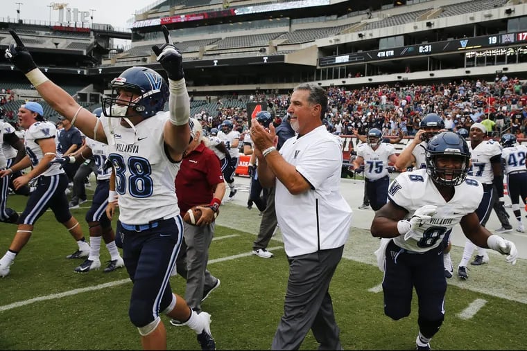Villanova head coach Mark Ferrante (center) celebrates his teams 19-17 win over Temple with players defensive back Chucky Smith (left) and running back D'Andre Pollard on Saturday, September 1, 2018. YONG KIM / Staff Photographer