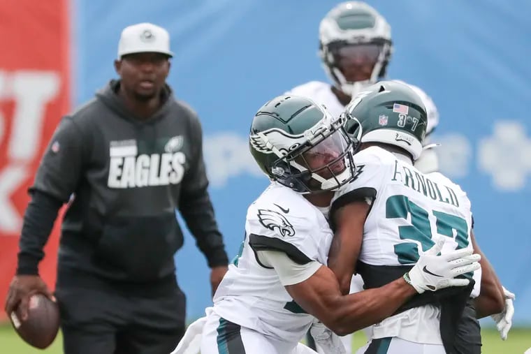 Eagles cornerback Zech McPhearson (left) runs a drill on defensive back Grayland Arnold (37) during training camp at the NovaCare Complex in South Philadelphia on Wednesday, Aug. 4, 2021.