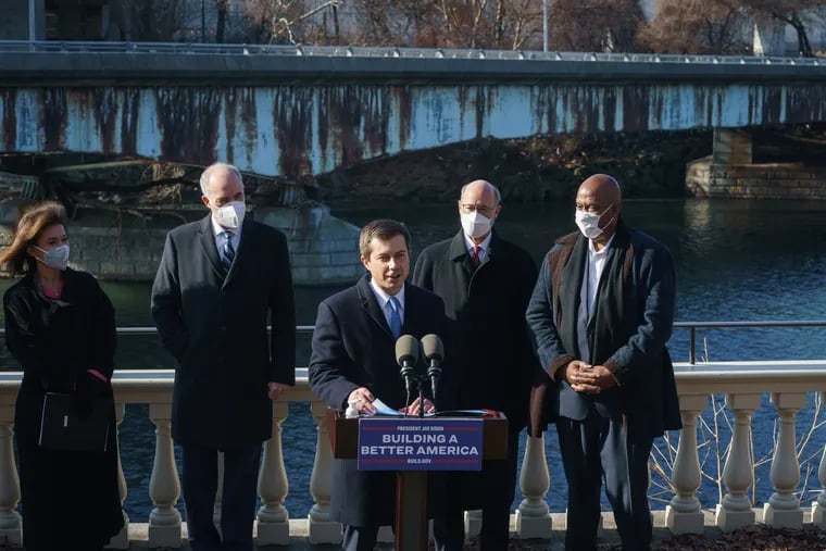 Secretary of Transportation Pete Buttigieg speaks at a press conference in front of the Martin Luther King Bridge on Friday, where he talked about the infrastructure law's money for repair of small, local ailing bridges around the United States. (Left to Right behind the podium) Yassmin Gramian, Secretary of the Pennsylvania Department of Transportation, Senator Bob Casey, Governor Tom Wolf, and Congressman Dwight Evans.
