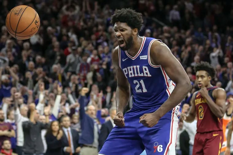 Sixers' Joel Embiid screams after his go-ahead dunk against the Cavaliers.