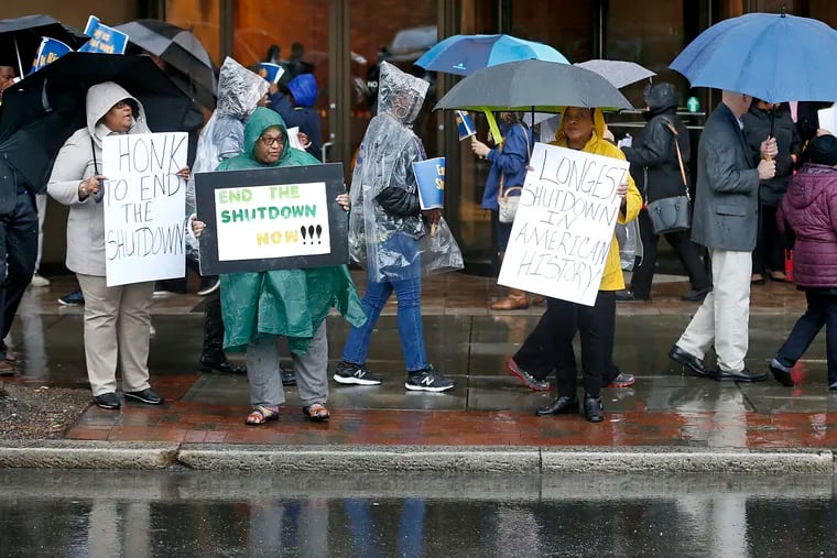 People demonstrate in Richmond, Va., to support The U.S. Department of Housing and Urban Development and Bureau of Prisons employees who are affected by the partial government shutdown on Thursday.