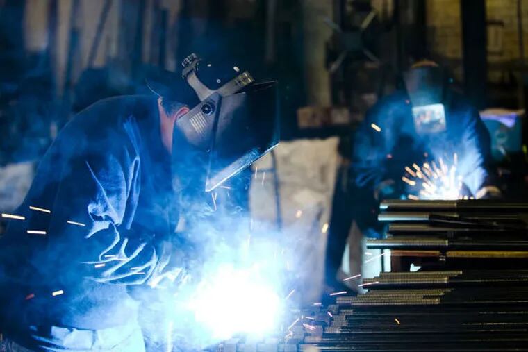 Welders fabricate bolts at Fox Co. Inc. in Philadelphia. The Federal Reserve Bank of Phila. says that manufacturing in the region is growing at its fastest pace in three years. (AP Photo)