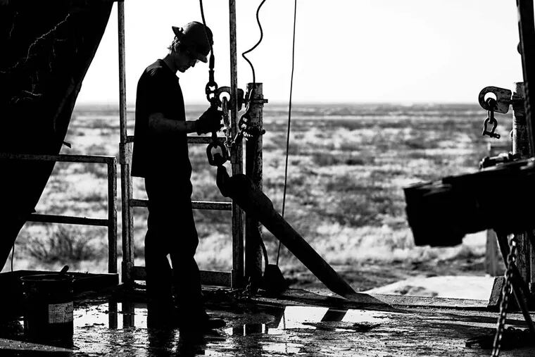 A worker on a rig near Midland, Texas, where shale oil extraction caused a boom. This boom spurred Saudi Arabia to maximize production, threatening to drive U.S. producers out of business.