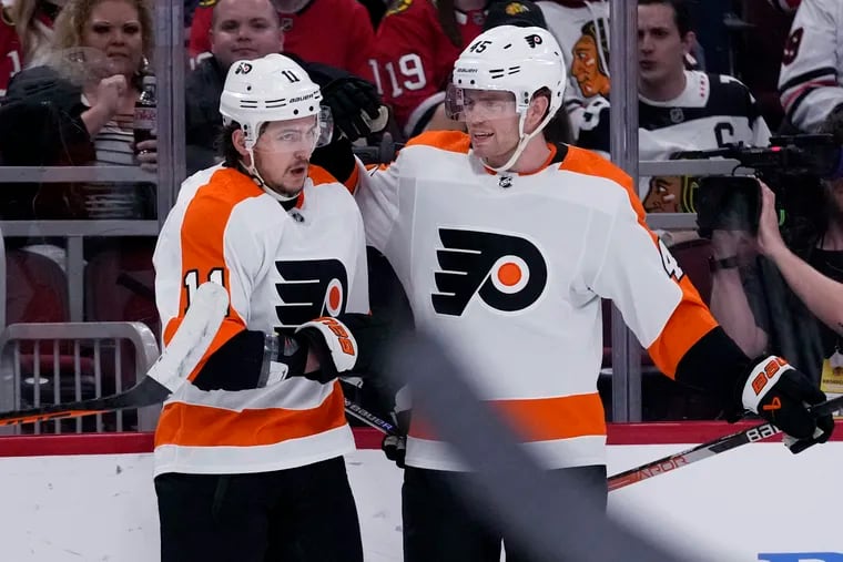 Philadelphia Flyers right wing Travis Konecny (left) celebrates one of his first-period goals with Cam York on Thursday night against the Blackhawks.
