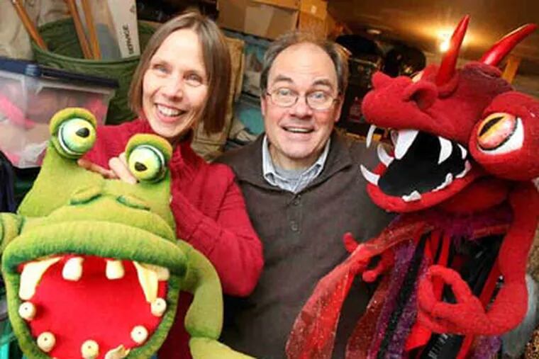 Monster puppets from Enchantment's producton of "Scheherazade" are as big as Jennifer and Landis Smith, who can't escape a creative vibe: Their Glenside home is the workplace for creation of their stage shows. (Charles Fox / Staff Photographer)