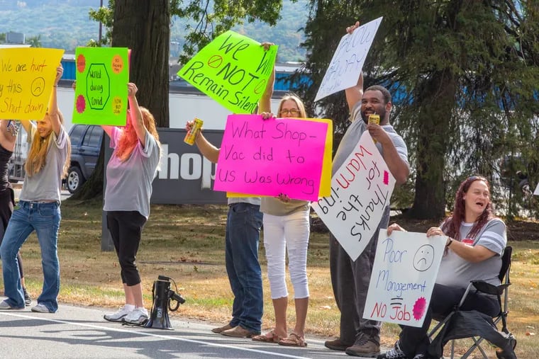 Terminated Shop Vac employees picket in front of the company's headquarters in Williamsport, Pa., in September. The company abruptly announced its closure on Sept. 15.