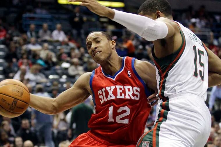 The Sixers' Evan Turner drives past the Bucks' Tobias Harris in the first half of the game in Milwaukee. Turner led all scorers in the game with 29 points.