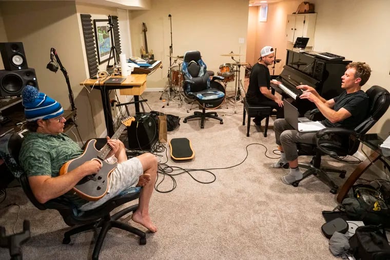Disco Biscuits musicians Jon Gutwillig (left) and Aron Magner (center) with writer Nick Schmidle during a songwriting session at Gutwillig's home studio in Malvern.