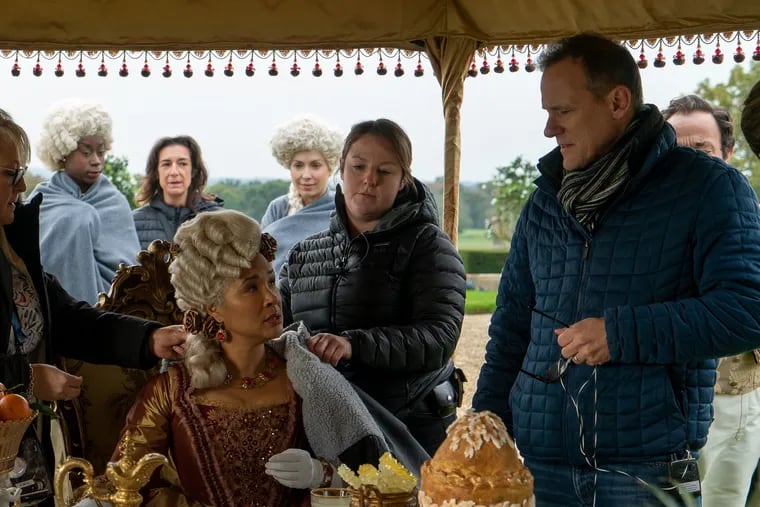 Director Tom Verica (right) on the set of Netflix's "Bridgerton" with Golda Rosheuvel (seated), who plays Queen Charlotte.