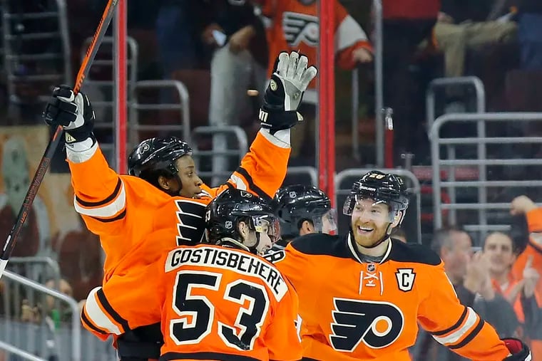 Wayne Simmonds (left) celebrating one of the 204 goals he scored as a Flyer with teammates Shayne Gostisbehere and Claude Giroux. He plays now for his hometown Maple Leafs.